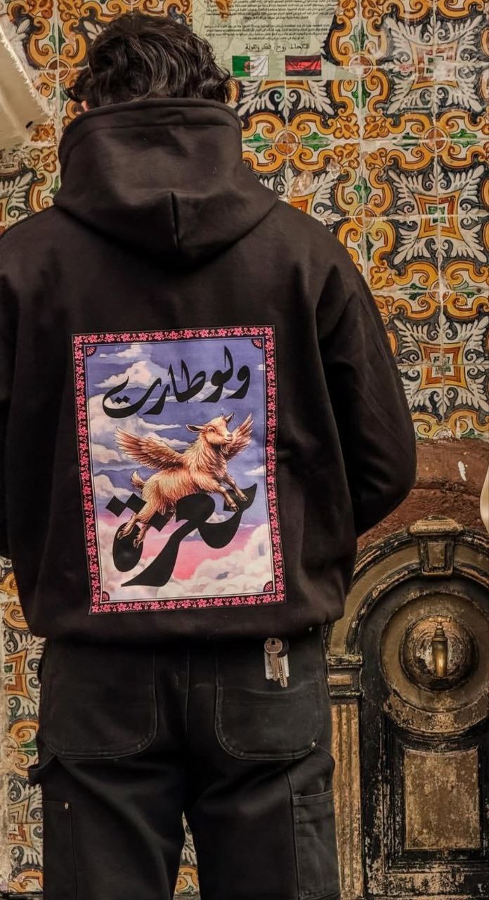 H'NA hoodie featuring Arabic calligraphy and winged goat design
